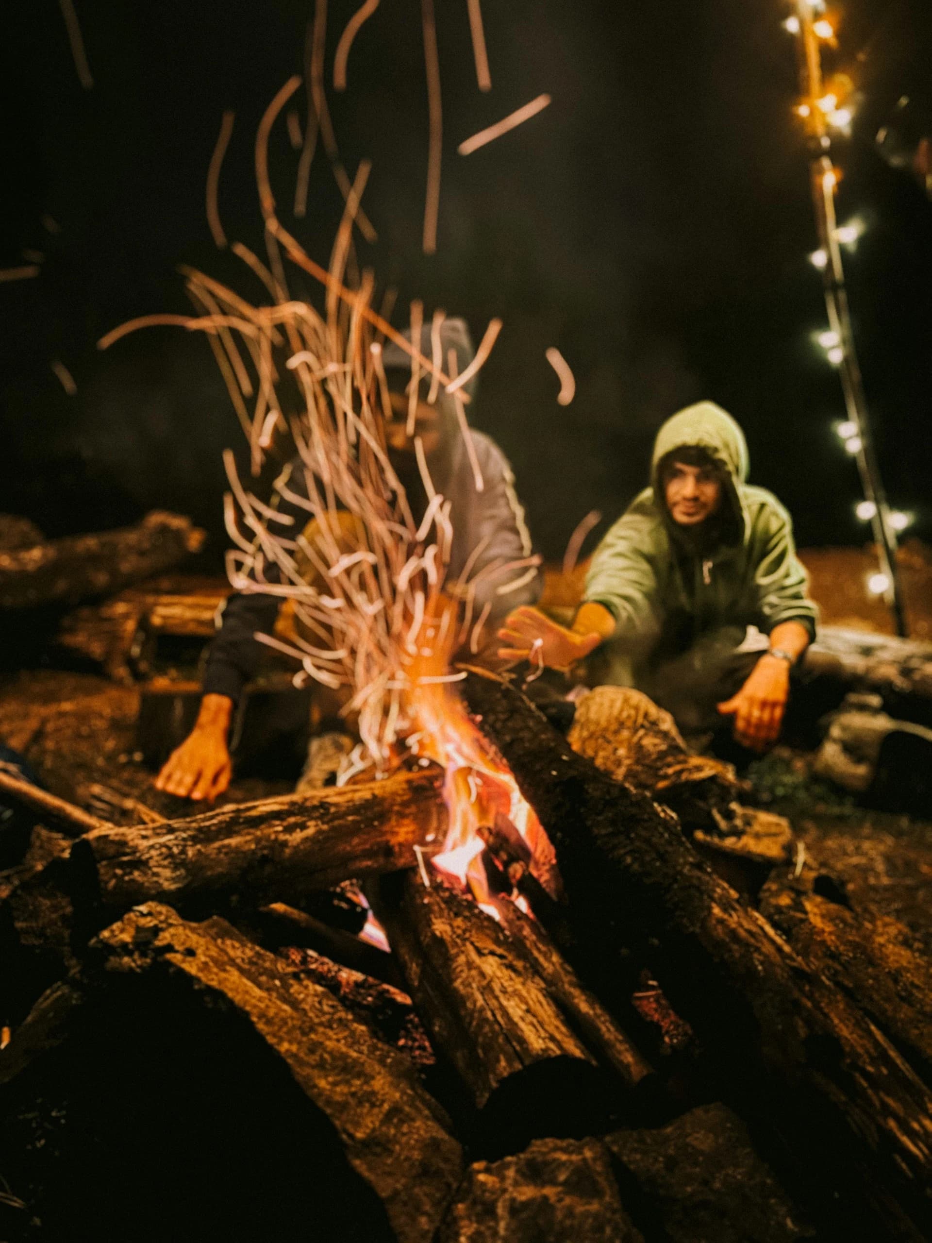 Guests gathered around an evening campfire