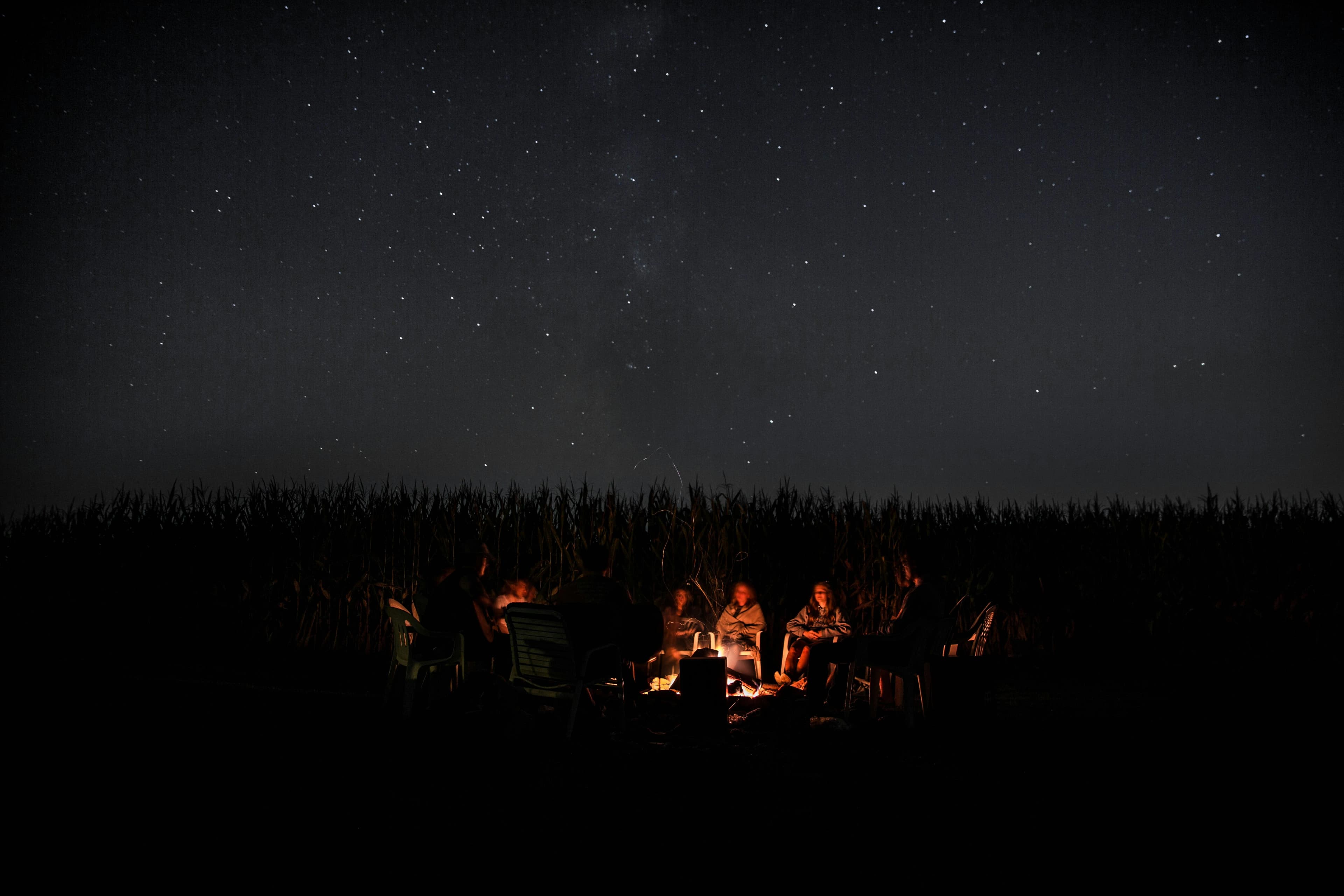 Guests gathered around an evening campfire at Blue Bell